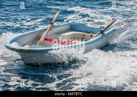 Lonely rowboat in the muddle of the endless sea Stock Photo
