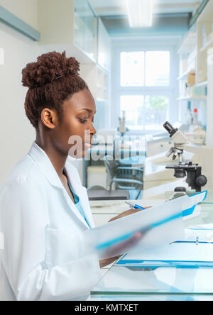 African scientist, medical worker, tech or graduate student works in modern biological laboratory Stock Photo