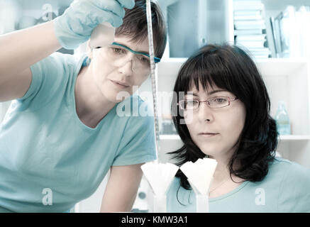 Two female scientists make maxiprep in the lab Stock Photo