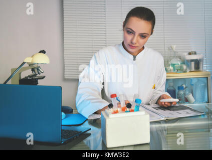 Physician or medtech in white coat working with patients samples. Stock Photo