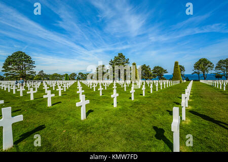 The Normandy American Cemetery and Memorial at Colleville-sur-Mer on a sunny day with rows of gravestones honoring the fallen soldiers Stock Photo