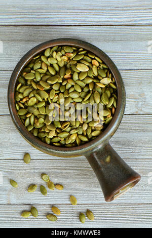 Download Raw Pumpkin Seeds In Earthenware Bowl And Miniature Pumpkin On Grey Stock Photo Alamy PSD Mockup Templates