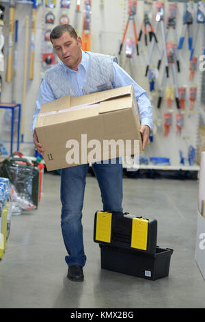 porter carrying boxes in a warehouse Stock Photo
