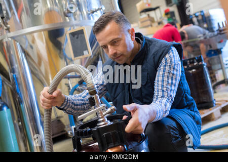 male plumber checking electric boiler Stock Photo