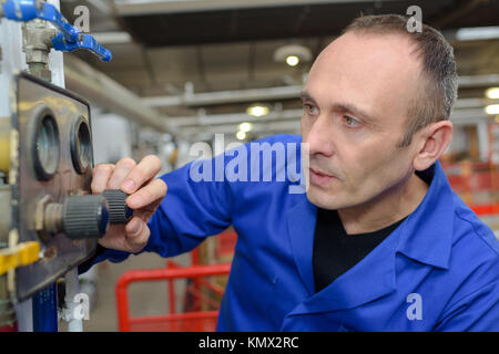 machinist doing some adjustment on the setting Stock Photo