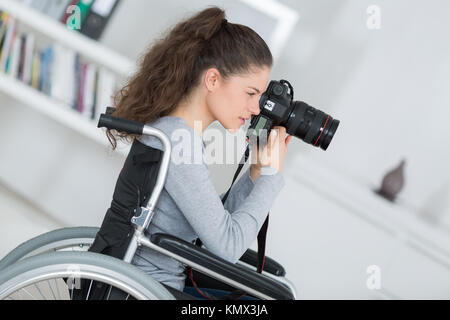 woman in wheelchair training to become photographer Stock Photo