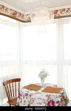 interior of modern kitchen, view of a window and little table with chairs, a vertical shot Stock Photo