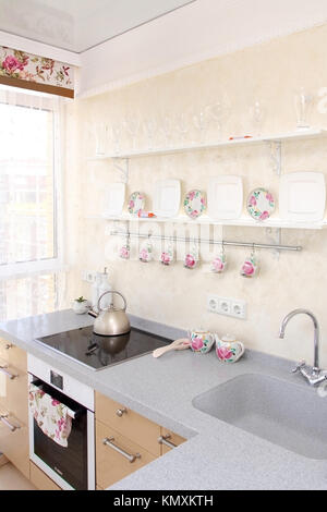 interior of modern kitchen, view of a window, plate and sink, vertical shot Stock Photo