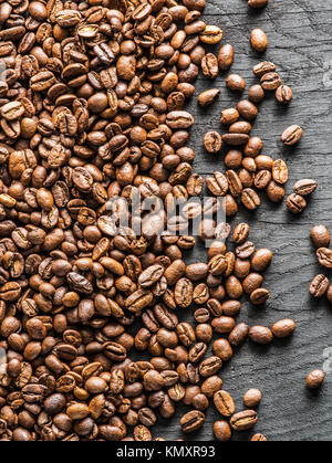 Roasted coffee beans on the old wooden background. Top view. Stock Photo