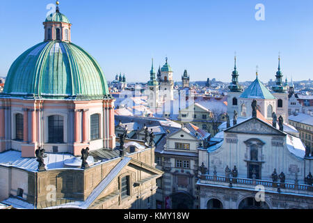 klementinum, saint Salvadore church, Old town hall tower, wintertime snowy day - snow covered towers of Prague (UNESCO), Czech republic Stock Photo