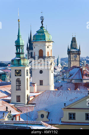 klementinum, saint Salvadore church, Old town hall tower, wintertime snowy day - snow covered towers of Prague (UNESCO), Czech republic Stock Photo