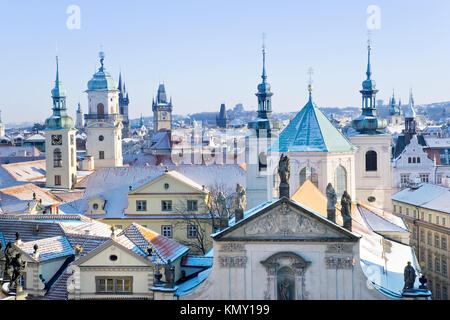 klementinum, saint Salvadore church, Old town hall tower, wintertime snowy day - snow covered towers of Prague (UNESCO), Czech republic Stock Photo