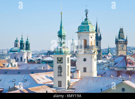 klementinum, saint Salvadore church, Old town hall tower, wintertime snowy day - snow covered towers of Prague (UNESCO), Czech republic Stock Photo