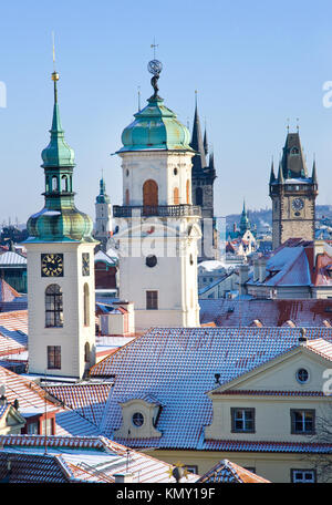 klementinum, saint Salvadore church, Old town hall tower, wintertime snowy day - snow covered towers of Prague (UNESCO), Czech republic Stock Photo