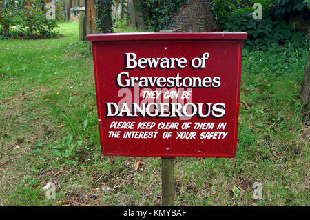 Humour  (unintentional) - old sign 2007 -   Great Ayton village Church cemetery, Yorkshire UK - 'BEWARE OF GRAVESTONES THEY CAN BE DANGEROUS' Stock Photo