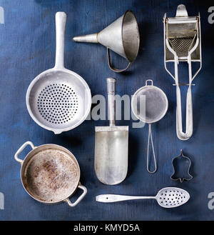 Set of vintage aluminum cookware over dark blue canvas as background. Top view Stock Photo