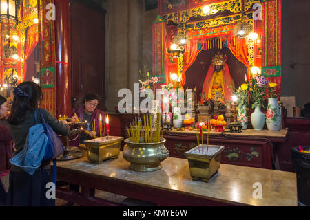People praying in front of the altar in Pak Tai Temple in Hong Kong Stock Photo