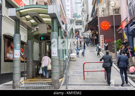 People walking on the streets and a view of Central-Mid levels escalator in Hong Kong Stock Photo