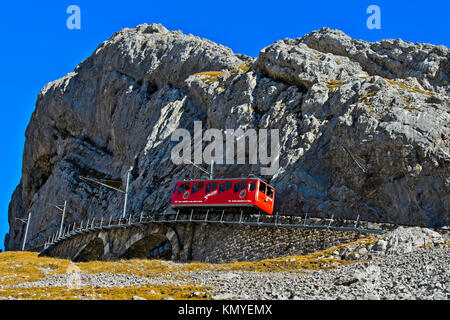 Red railcar of the Pilatus Railway on the way to the top, Pilatus massif, Alpnachstad near Lucerne, Switzerland Stock Photo