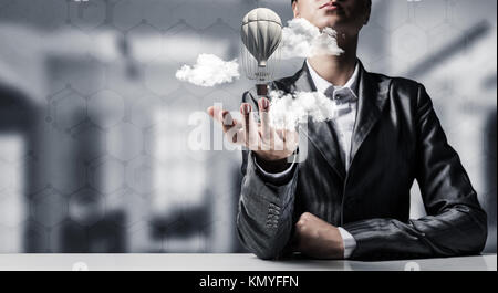 Woman presenting flying balloon in hand. Stock Photo