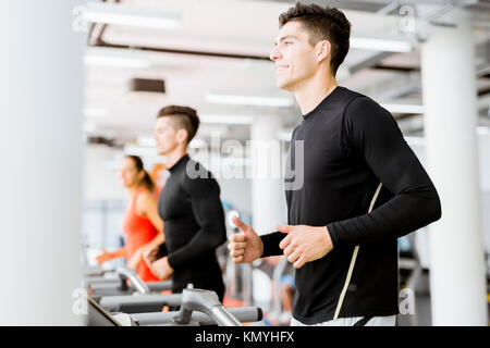 Group of young people using treadmills in a gym Stock Photo