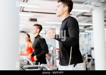 Group of young people using treadmills in a gym Stock Photo