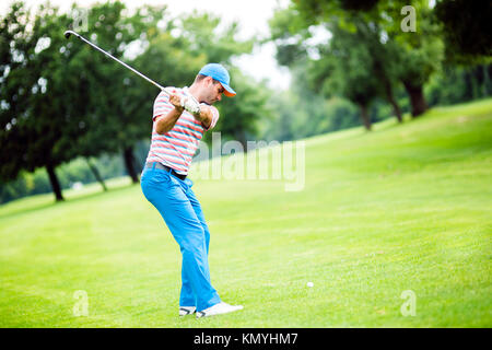 Golfer practicing and concentrating before and after shot Stock Photo