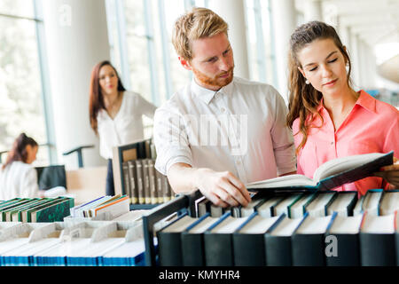 Two students reading and studying in library Stock Photo