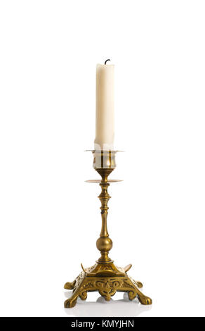 Antique brass candlestick with candle isolated on a white background Stock Photo