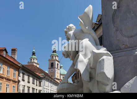 The Robba Fountain, also known as the Fountain of the Three Carniolan Rivers, detail, Ljubljana, Slovenia. Cathedral of St. Nicholas in the background Stock Photo