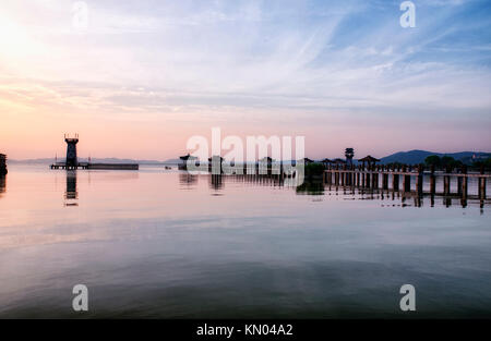 A long pier and asian covered gazebos over the water of Tai Lake at the Three Kingdoms Scenic area. Stock Photo