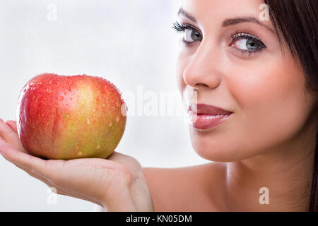 Beautiful young woman holding red apple Stock Photo