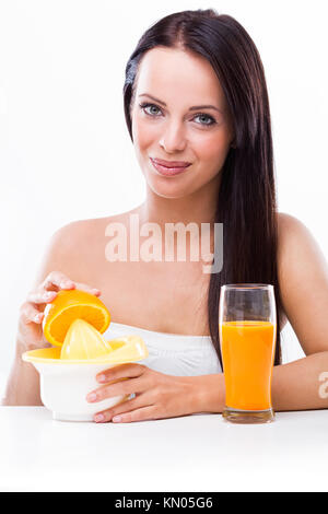 Beautiful woman with a juicer and oranges Stock Photo