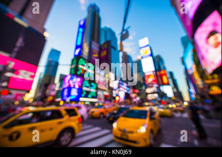 Abstract defocus view of New York yellow taxi traffic driving under the colourful neon lights of Times Square at night in NYC Stock Photo