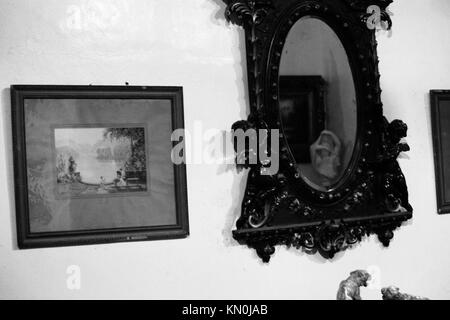 a view of framed art hanging on a wall in Penang Malaysia Stock Photo