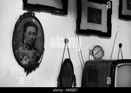 a view of framed art hanging on a wall in Penang Malaysia Stock Photo