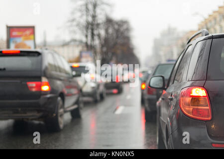 Cars in a traffic jam on a city street  on wet  road after rain. Stock Photo