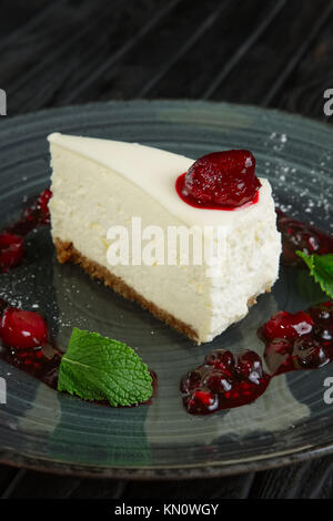 Top view of cherry-berry cheesecake on a wooden board and on a white ...