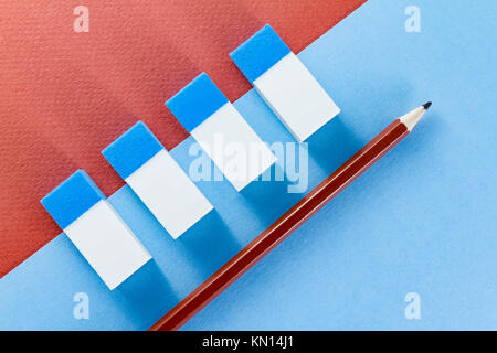 Top view of blue and white erasers on blue and brown color papers background Stock Photo