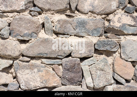 Fort solid stone wall texture with sand sandwich texture wet soil reserves used for construction and for decoration purpose grey color big and small Stock Photo