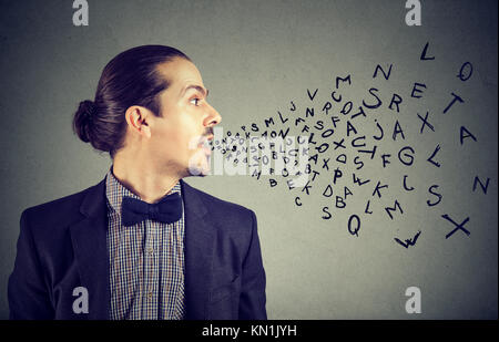 Man talking with alphabet letters coming out of his mouth. Communication, information, intelligence concept Stock Photo