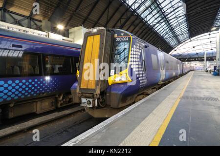 Glasgow Queen Street Station, Glasgow, United Kingdom, Sunday 10th December 2017. Scotrail have commenced an electric train service on the Edinburgh to Glasgow main line. The electrification project for this line, known as EGIP, has suffered a number of set backs and delays but today the first passenger carrying trains have operated. The new Class 385 trains which have been ordered to run the  service are not yet ready and as a temporary measure some Class 380 electric trains have been brought into service. Credit: Garry Cornes/Alamy Live News