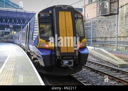 Glasgow Queen Street Station, Glasgow, United Kingdom, Sunday 10th December 2017. Scotrail have commenced an electric train service on the Edinburgh to Glasgow main line. The electrification project for this line, known as EGIP, has suffered a number of set backs and delays but today the first passenger carrying trains have operated. The new Class 385 trains which have been ordered to run the  service are not yet ready and as a temporary measure some Class 380 electric trains have been brought into service. Credit: Garry Cornes/Alamy Live News
