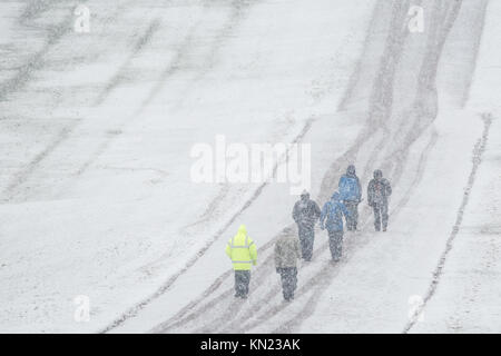 Windsor, UK. 10th December, 2017. People walk in the snow on the Long Walk in Windsor Great Park. Credit: Mark Kerrison/Alamy Live News
