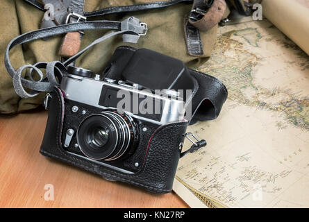 Items needed for travel: a large backpack, camera, map of the world. Vintage items in retro style Stock Photo