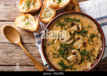 homemade thick mushroom soup and toast close-up on a table. horizontal top view from above Stock Photo