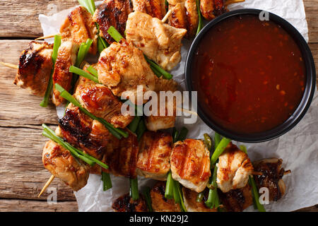 Chicken kebabs with green onions in a spicy sauce - Dakkochi close-up on the table. horizontal top view from above Stock Photo