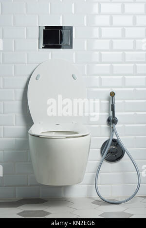 Modern clean white toilet seat in bathroom with elegant tile Stock Photo