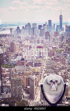 Vintage toned picture of tourist binoculars pointing at Manhattan skyline, New York City, USA. Stock Photo