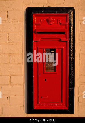 Red British posting box, rural Suffolk, England, United Kingdom Stock Photo